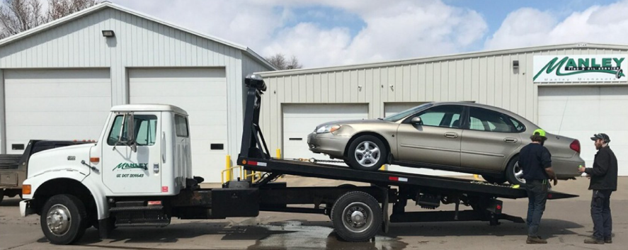 Flatbed tow truck with car in Valley Springs, SD